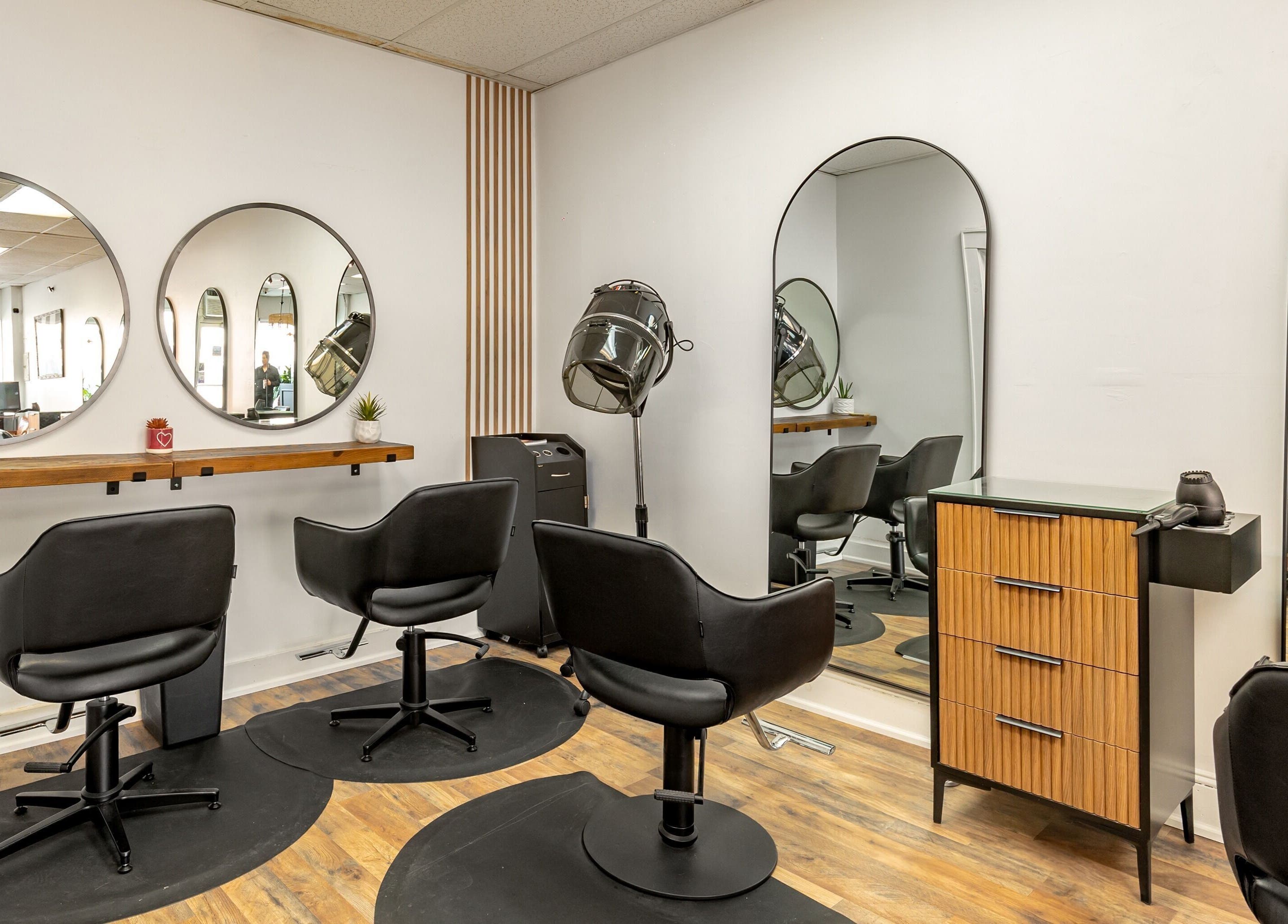 Modern salon chairs and mirrors at A&A Hairloft in Mineola, New York, US create a sleek styling space.