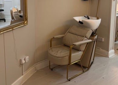 Chic hair wash station at Hair By Grace Crofton, Hoylake, England, GB, featuring a plush chair and ornate mirror.