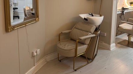 Chic hair wash station at Hair By Grace Crofton, Hoylake, England, GB, featuring a plush chair and ornate mirror.