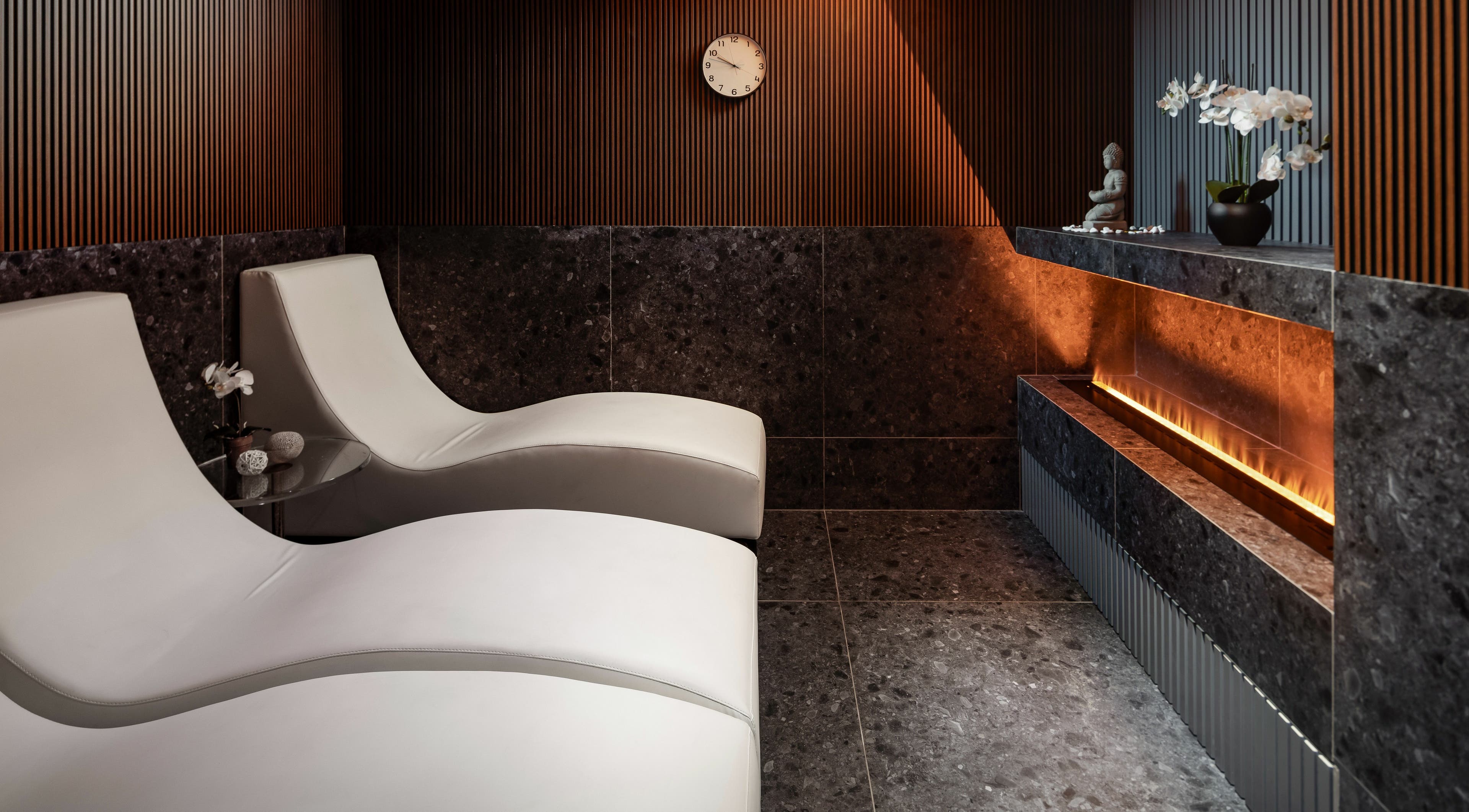 Luxurious lounge at Ease Spa, Gzira, MT featuring sleek chairs and ambient decor.