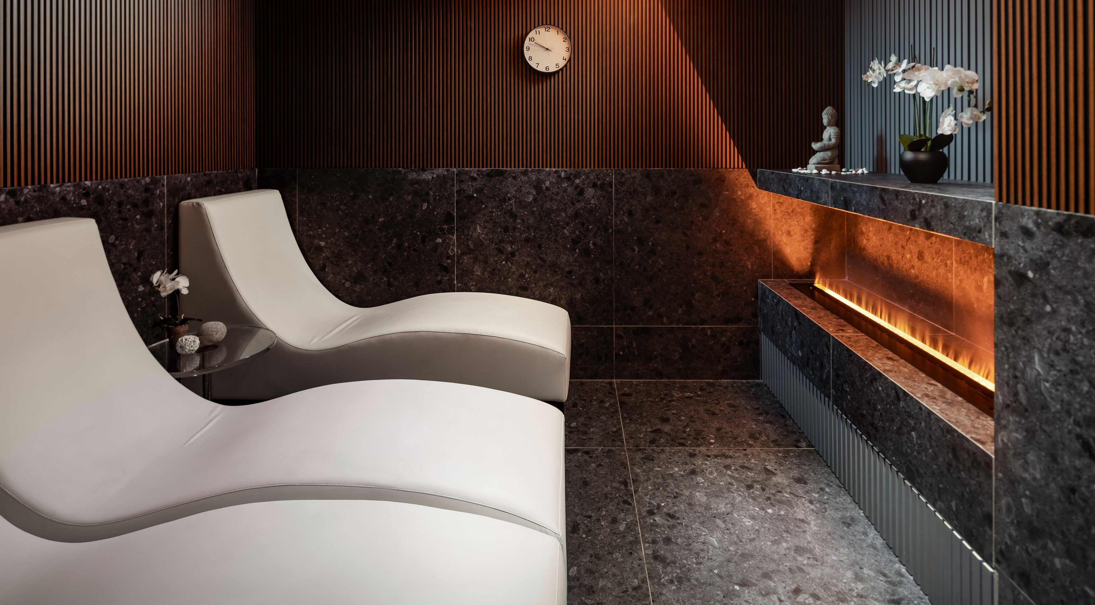 Luxurious lounge at Ease Spa, Gzira, MT featuring sleek chairs and ambient decor.