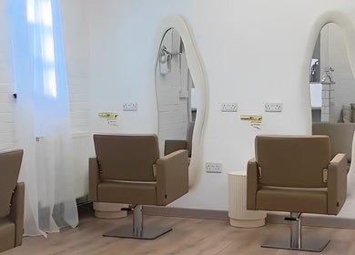 Stylish salon chairs and wavy mirrors at Saturate The Studio, Johnston, Wales, GB.