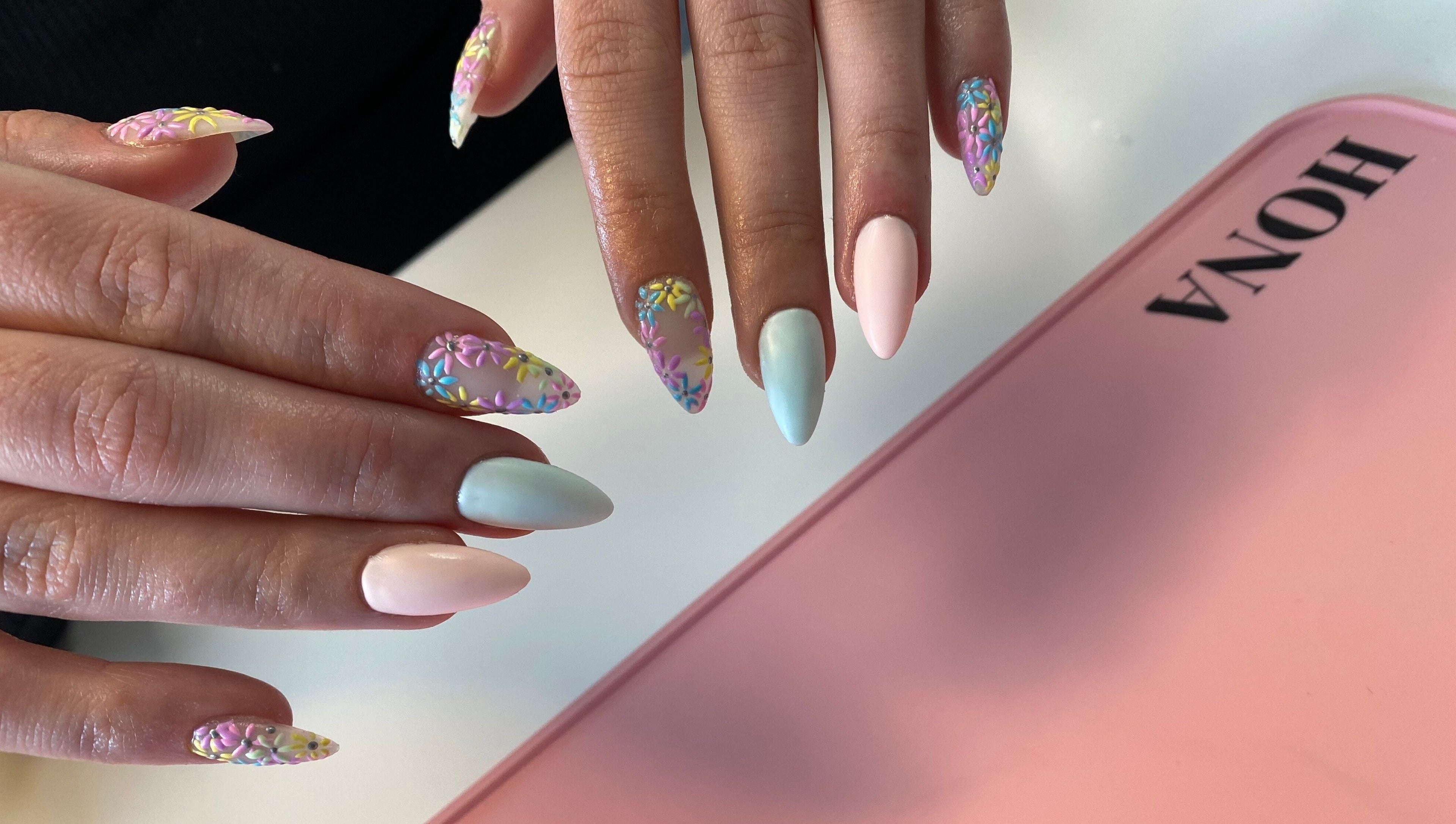 Vibrant 3D floral nail art at Nailed You By Lou, Stockport, England, GB, showcasing pastel elegance and creativity.