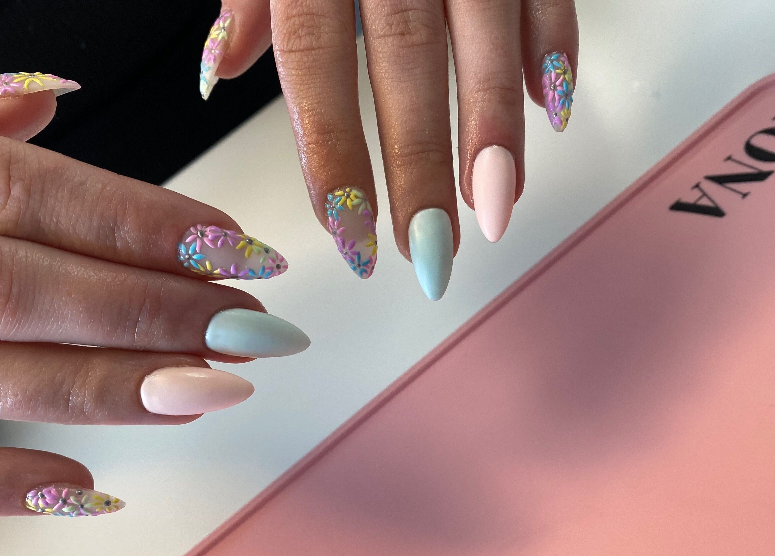 Vibrant 3D floral nail art at Nailed You By Lou, Stockport, England, GB, showcasing pastel elegance and creativity.