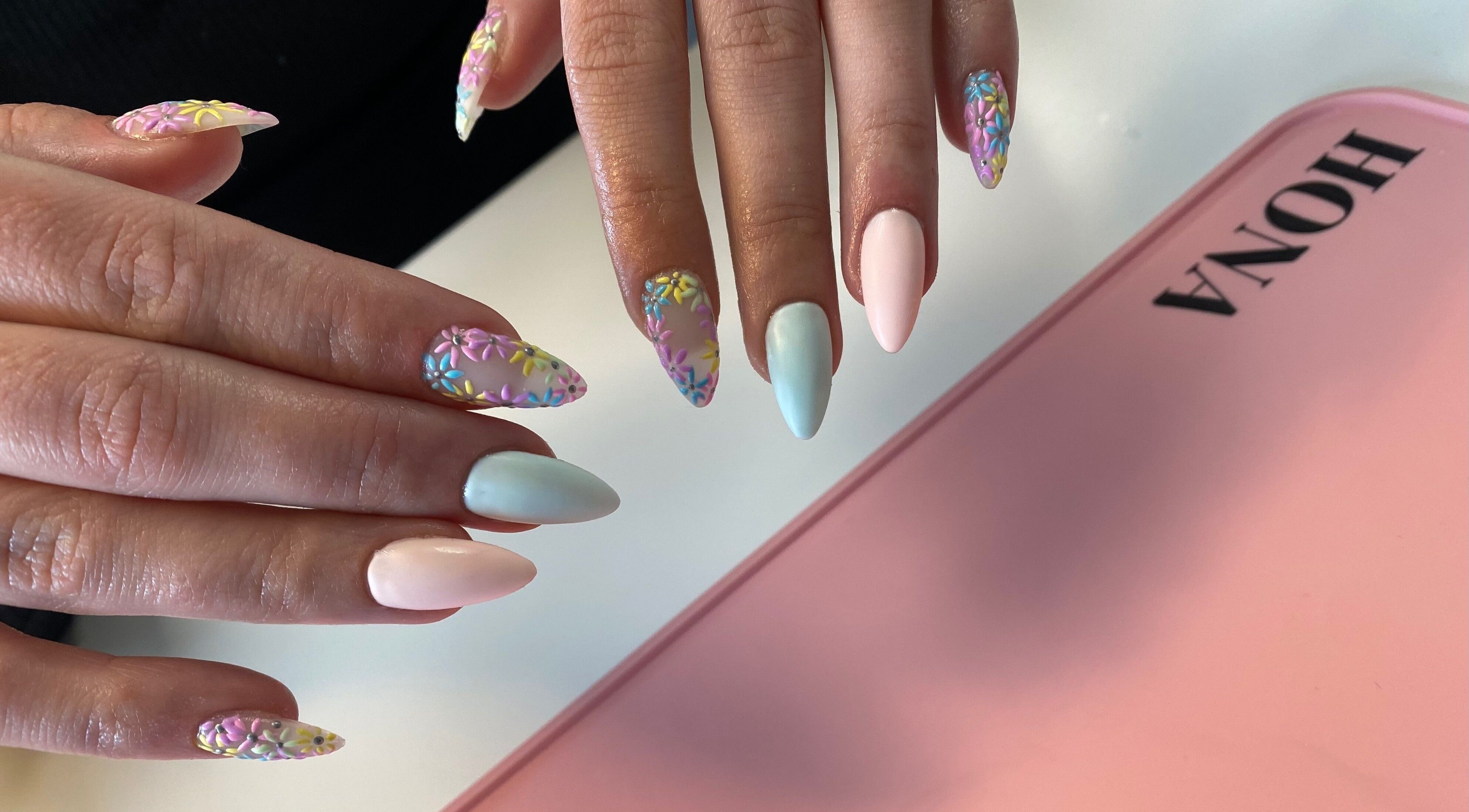 Vibrant 3D floral nail art at Nailed You By Lou, Stockport, England, GB, showcasing pastel elegance and creativity.