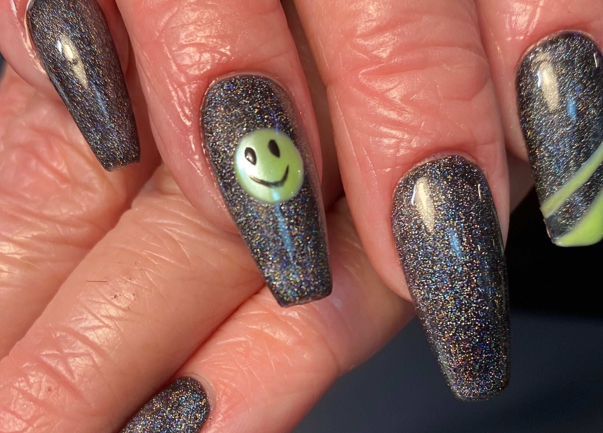 Glittery smiley face nail art at Nailed You By Lou, Stockport, England, GB.
