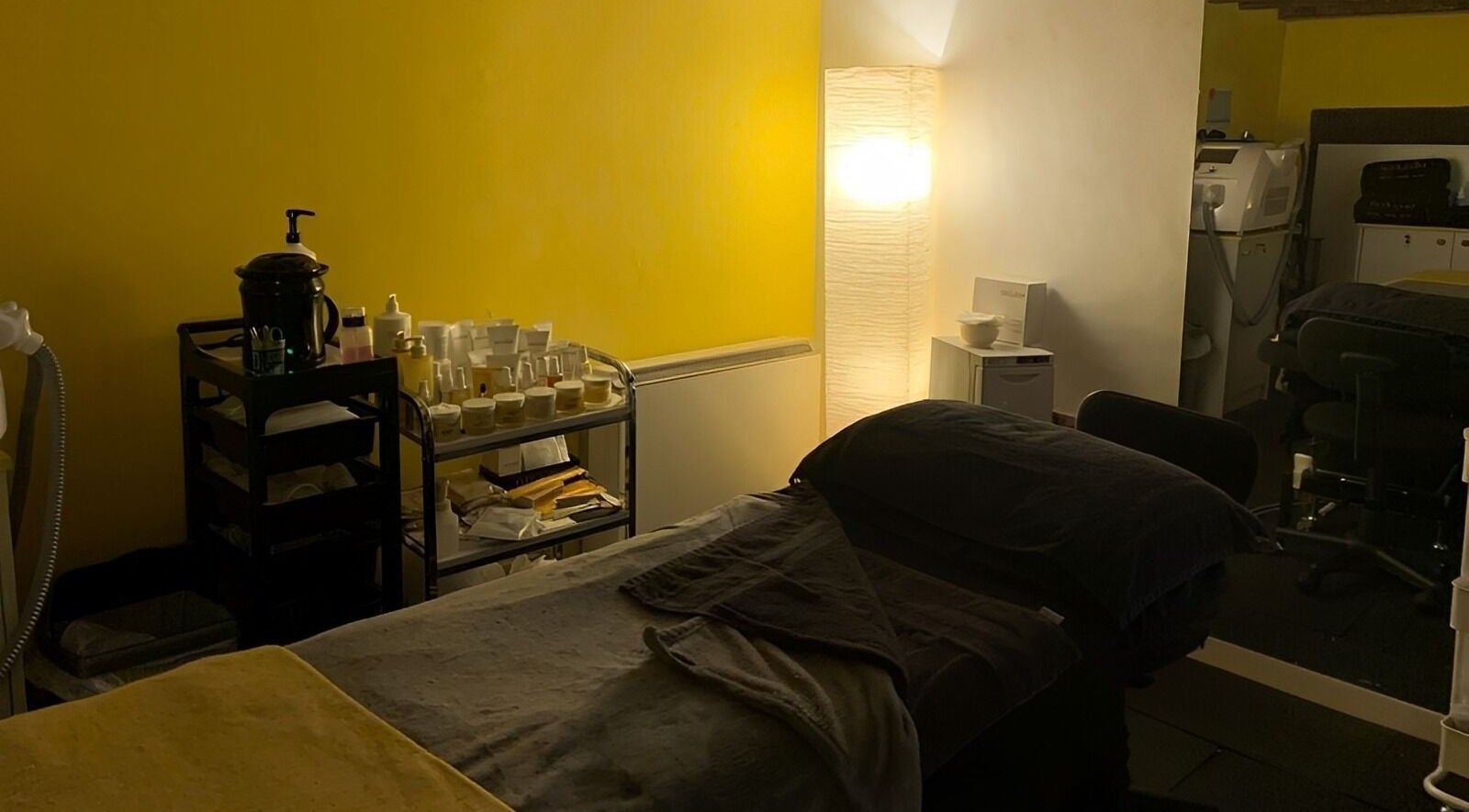 Cozy treatment room at Castle Beauty Salon, Kirkcudbright, Scotland, GB, featuring warm lighting and spa products.