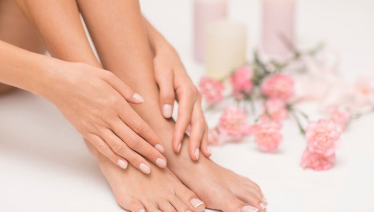 Close-up of manicured nails at Inspire Beauty at Traralgon, Traralgon, Victoria, AU with pink flowers decor.