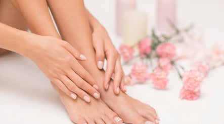 Close-up of manicured nails at Inspire Beauty at Traralgon, Traralgon, Victoria, AU with pink flowers decor.