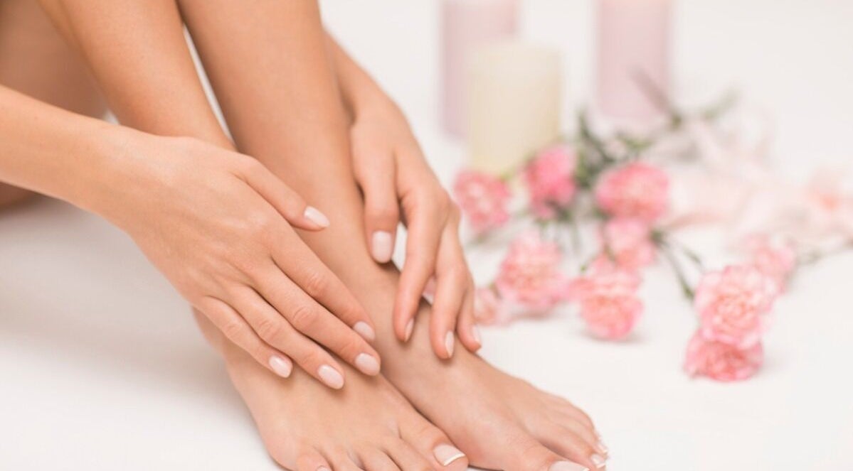 Close-up of manicured nails at Inspire Beauty at Traralgon, Traralgon, Victoria, AU with pink flowers decor.