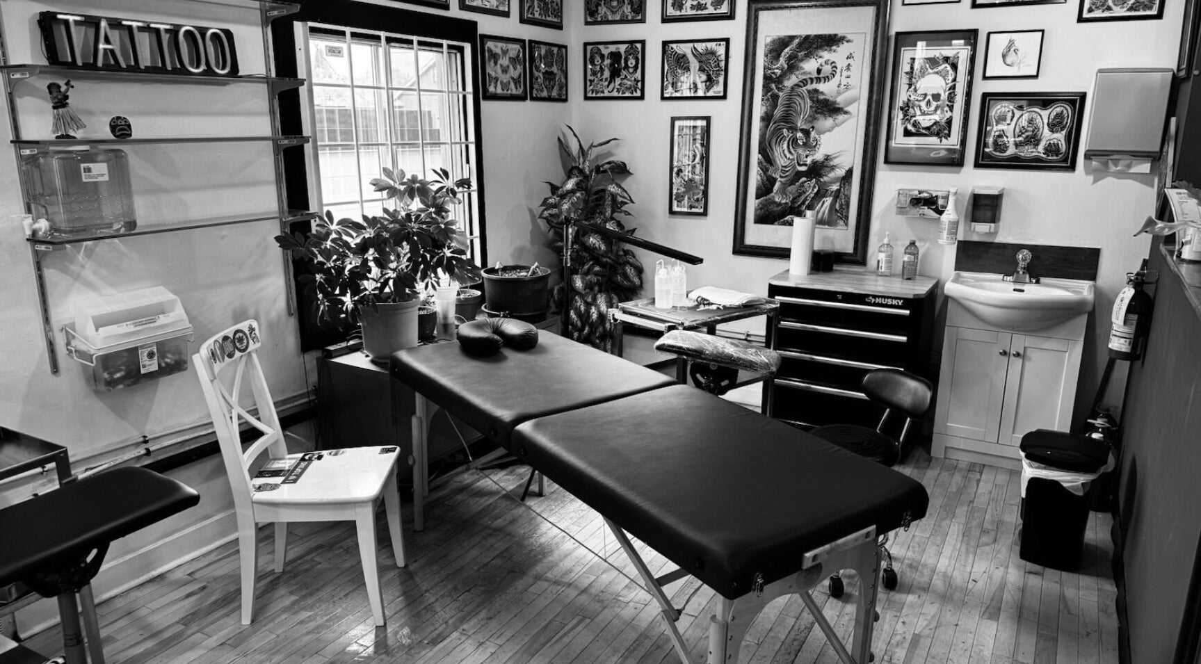 Tattoo studio interior at 1st Street Tattoo, Calgary, Alberta, CA, showcasing art and workspace.