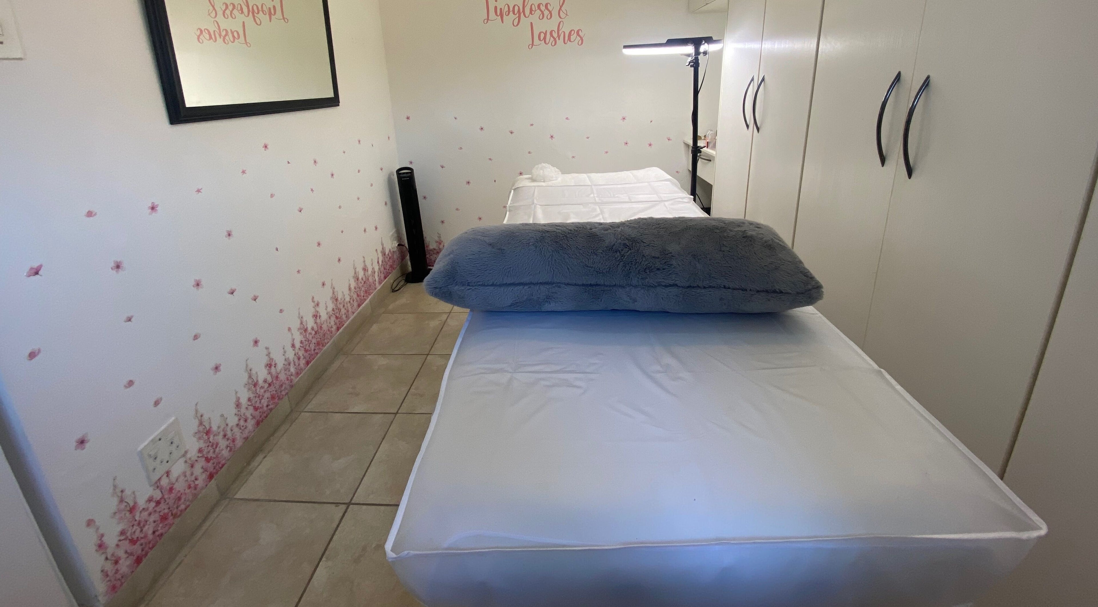 Relaxing treatment room at Lipgloss and Lashes Norwood, Johannesburg, Gauteng, ZA with plush bedding.
