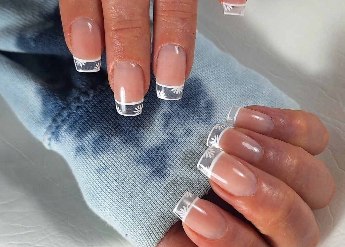Elegant French manicure with floral designs at michdylan, Benoni, Gauteng, ZA.