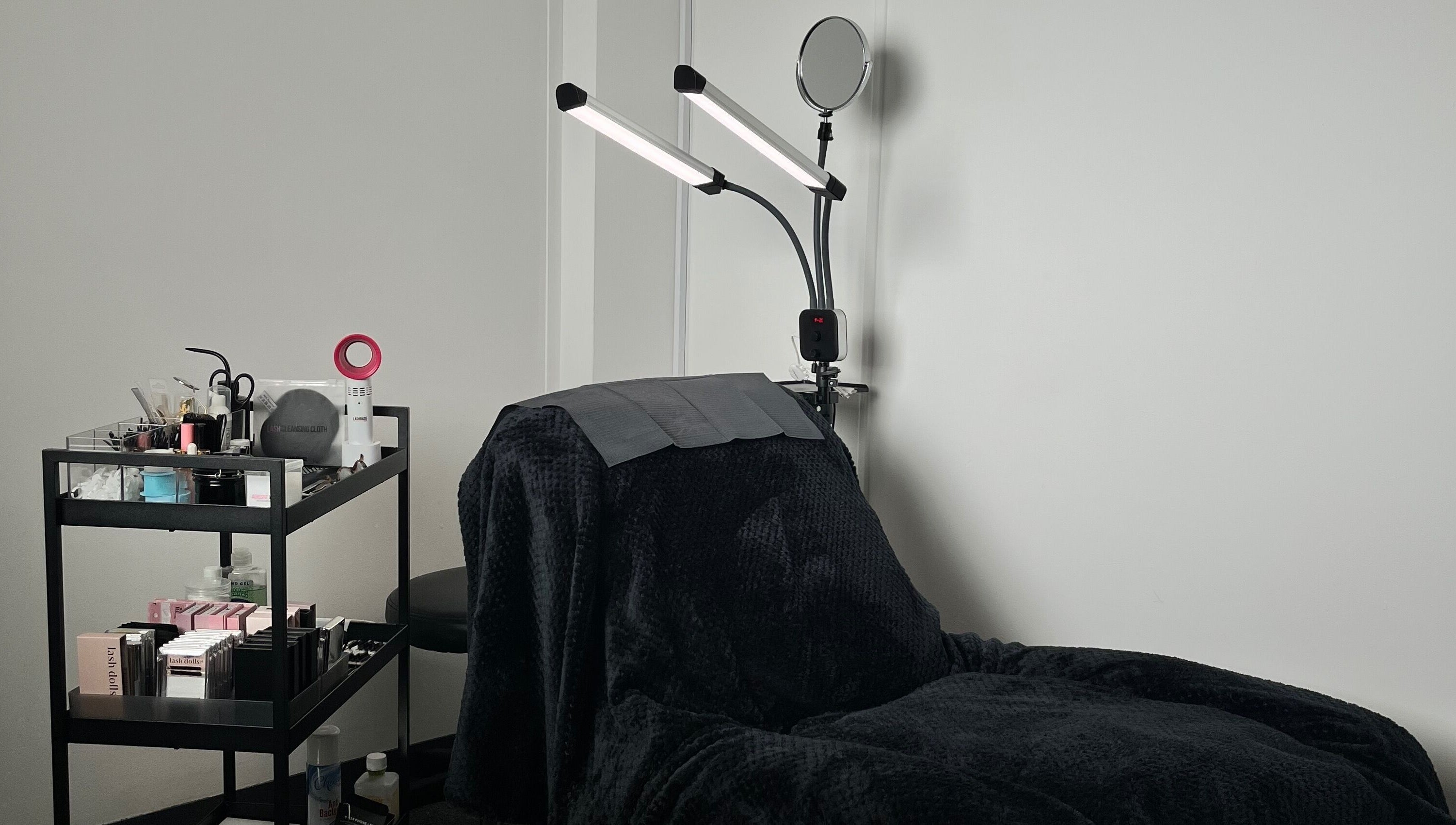 Definedbylashes' cozy treatment chair and tools in Birmingham, England, GB offers a serene wellness experience.