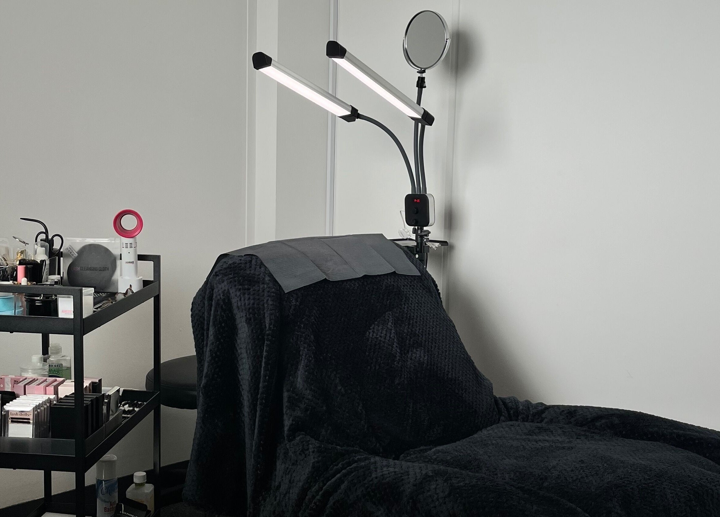 Definedbylashes' cozy treatment chair and tools in Birmingham, England, GB offers a serene wellness experience.