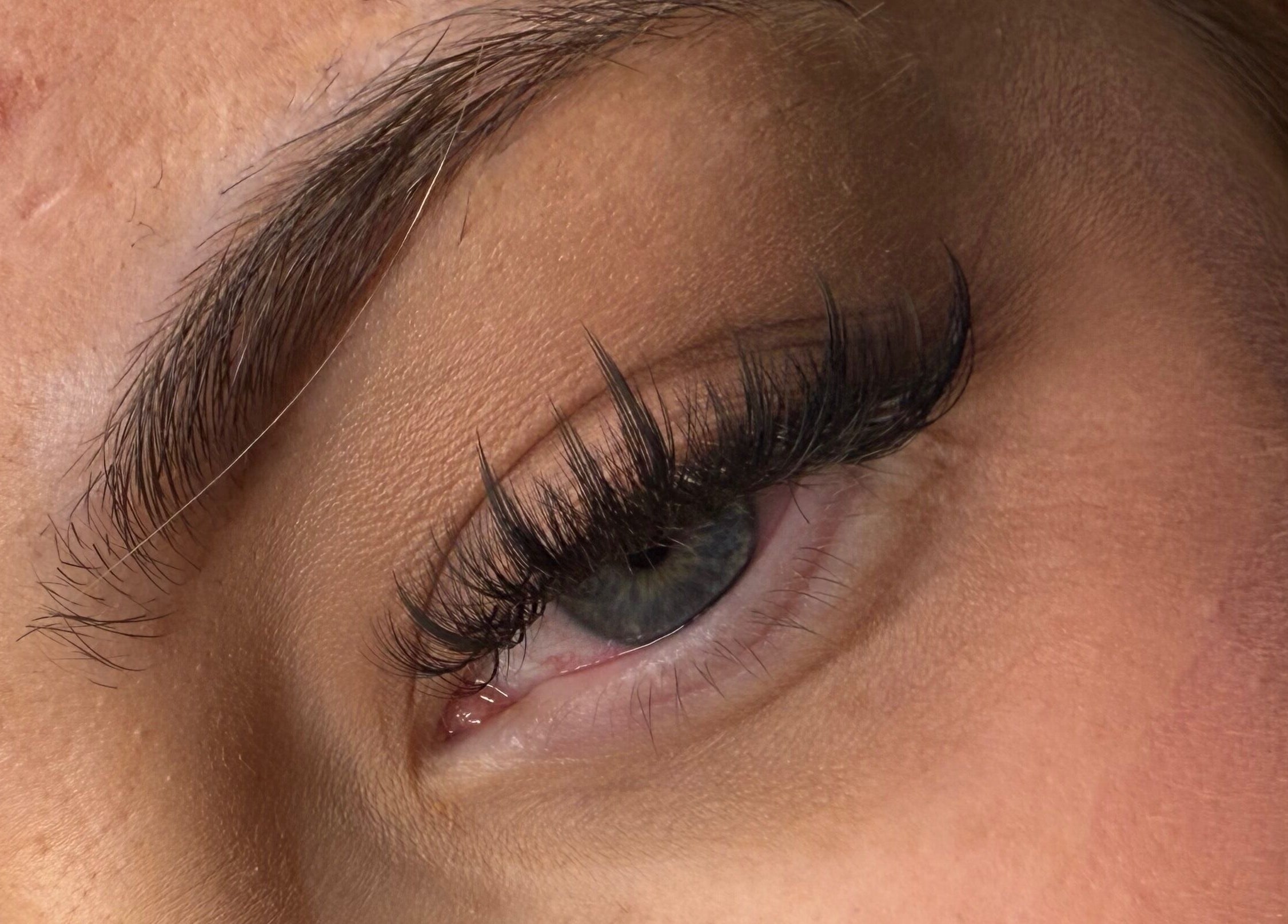 Close-up of beautifully enhanced eyelashes at Definedbylashes, Birmingham, England, GB.
