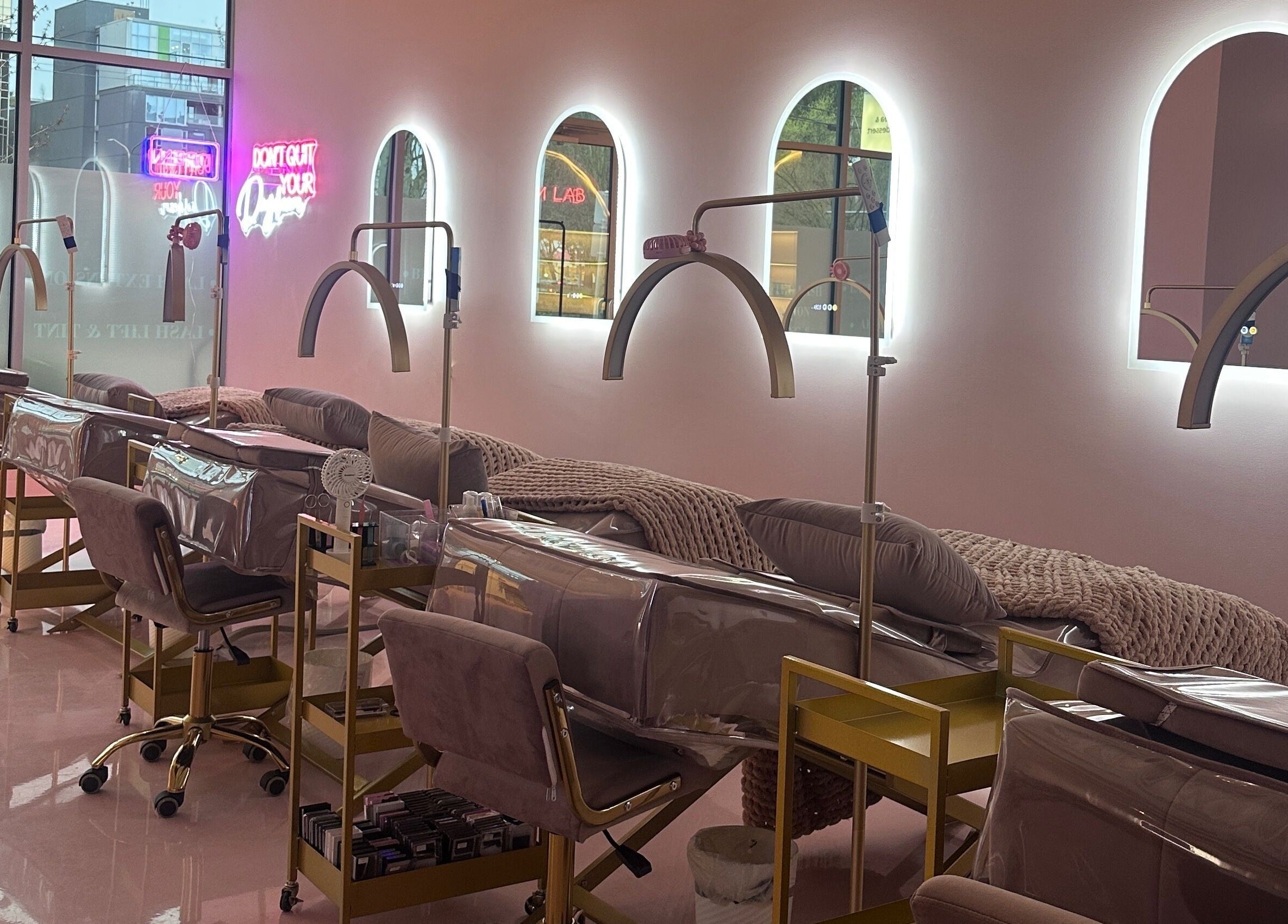 Luxurious interior of The Glam Lab beauty venue in Richmond, BC, featuring elegant treatment stations and ambient lighting.