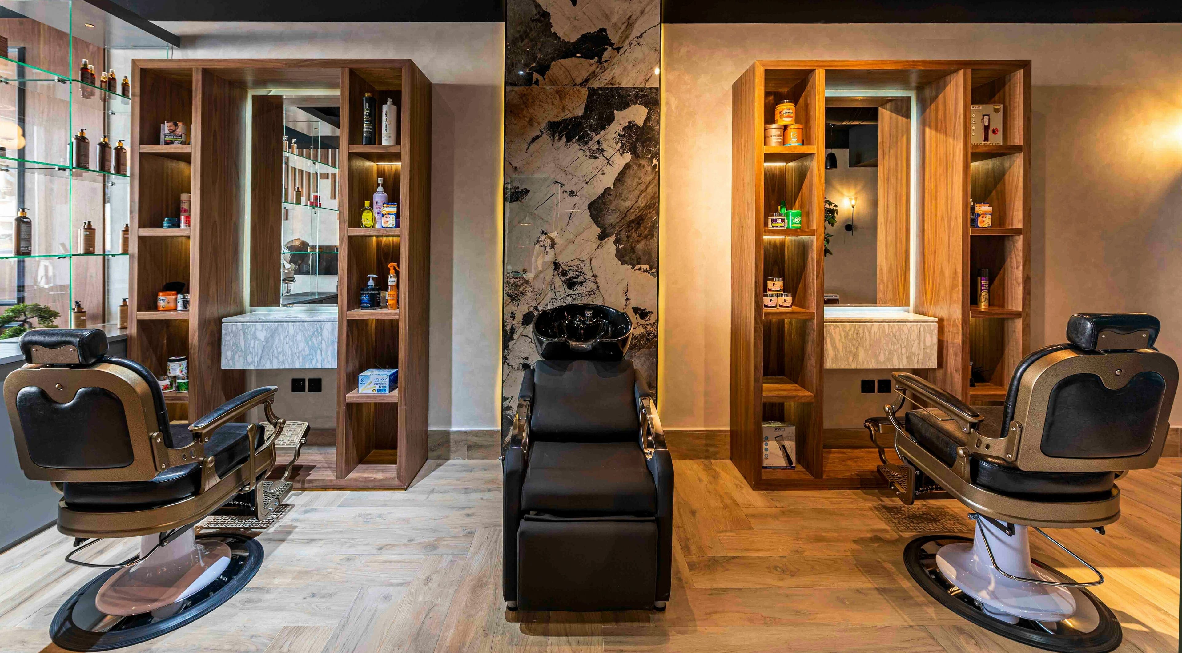 Modern interior of Smart Cuts Barbershop in Riyadh, with sleek barber chairs and shelving units.