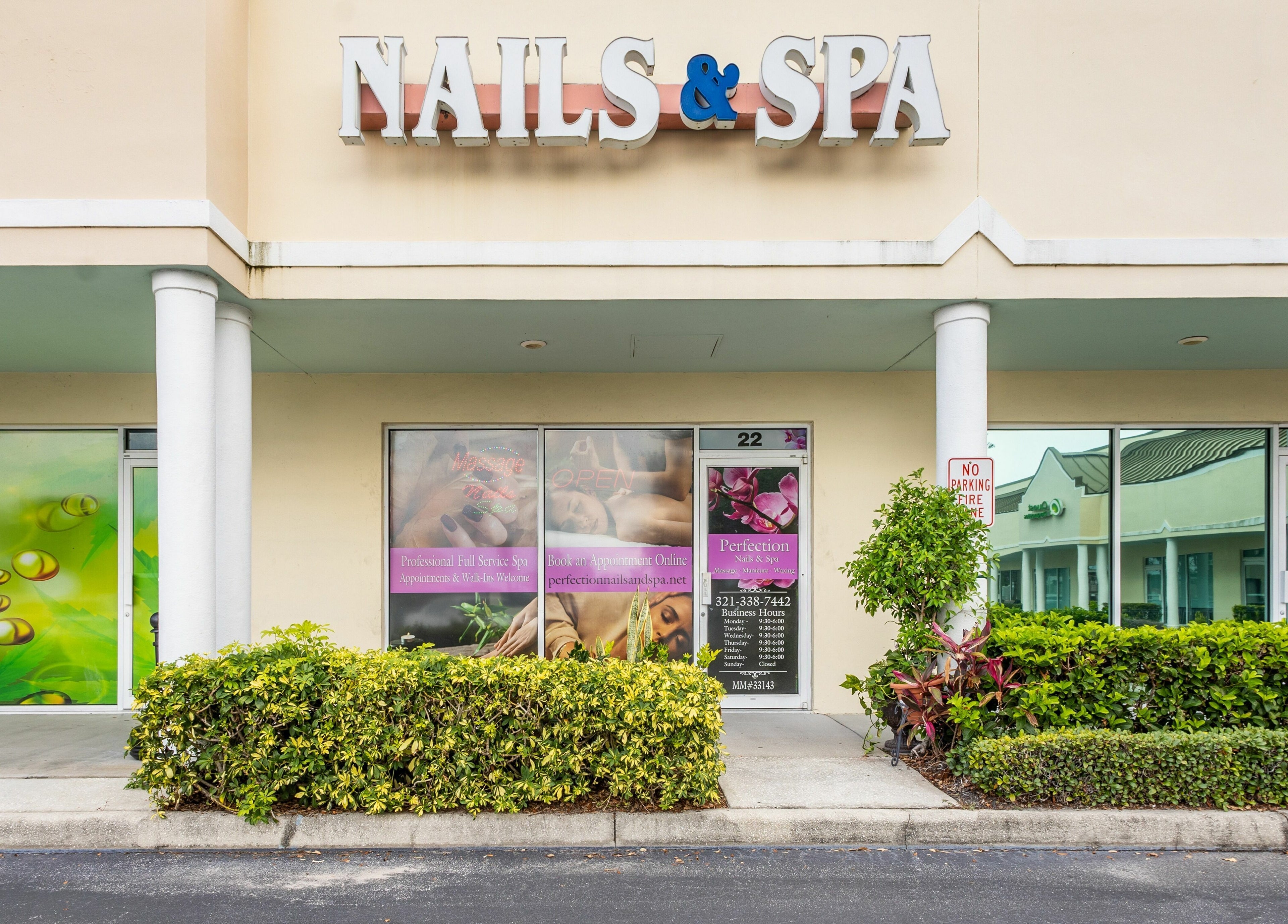 Exterior of Perfection Nails and Spa, Merritt Island, Florida, US, showcasing the welcoming sign and entrance.