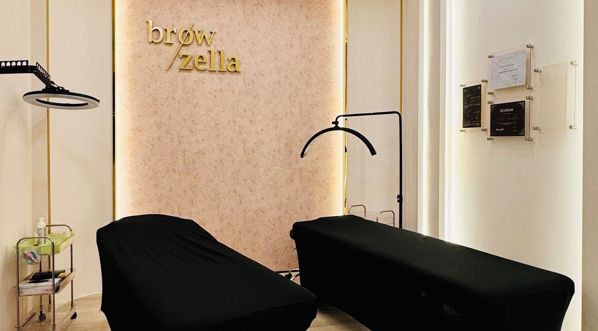 Elegant treatment room at Browzella, East Java, East Java, ID, showcasing two massage tables and soothing decor.