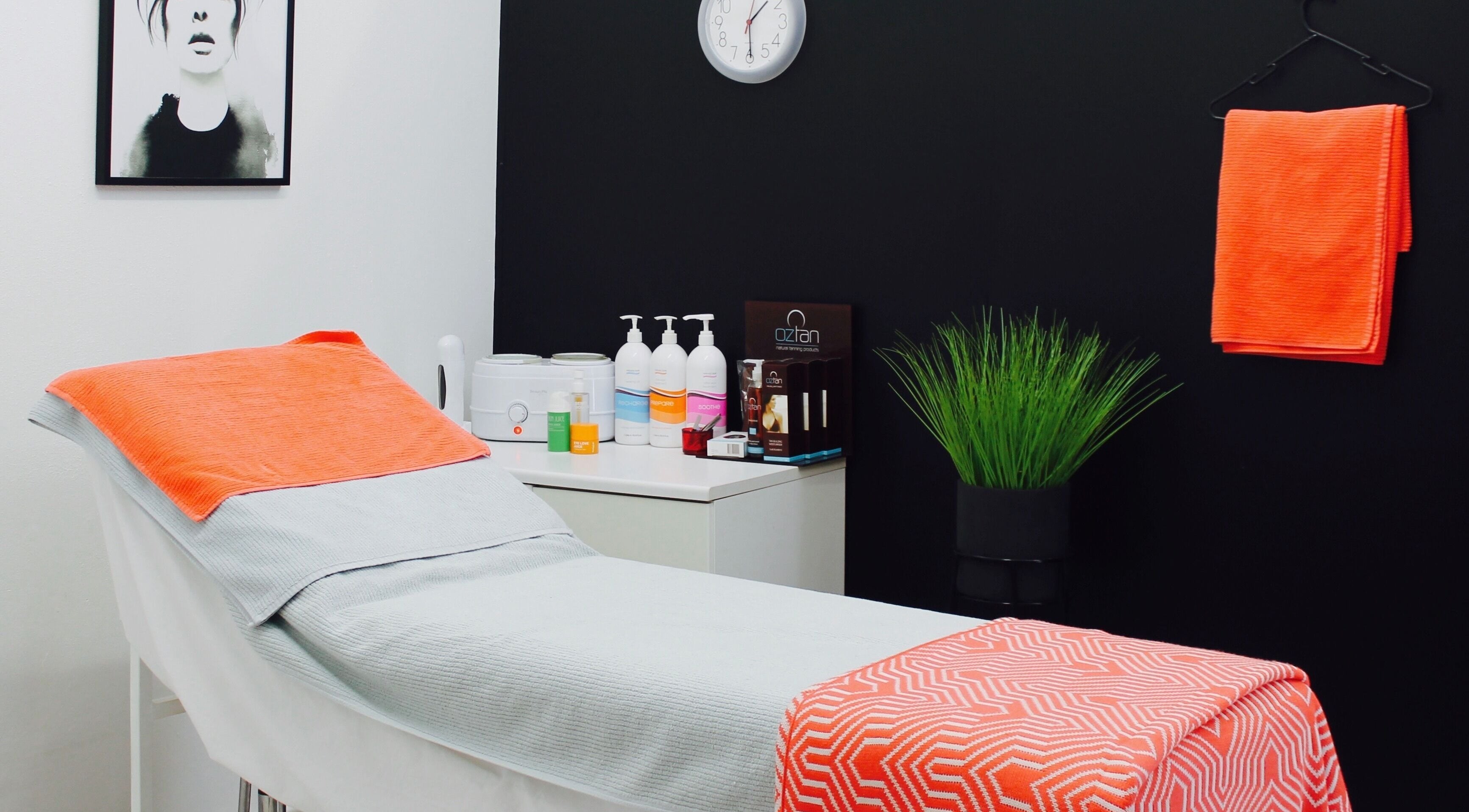 Cozy treatment room at Saron Beauty, Wembley, Western Australia, AU, featuring a massage table with orange decor.
