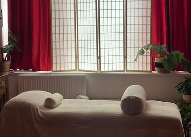 Relaxing massage room at The Talking Body Clinic, Glasgow, Scotland, GB with plush bed and ambient lighting.