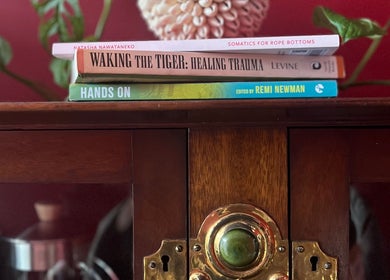 Books on a wooden cabinet enhance the serene ambiance at The Talking Body Clinic in Glasgow, Scotland, GB.