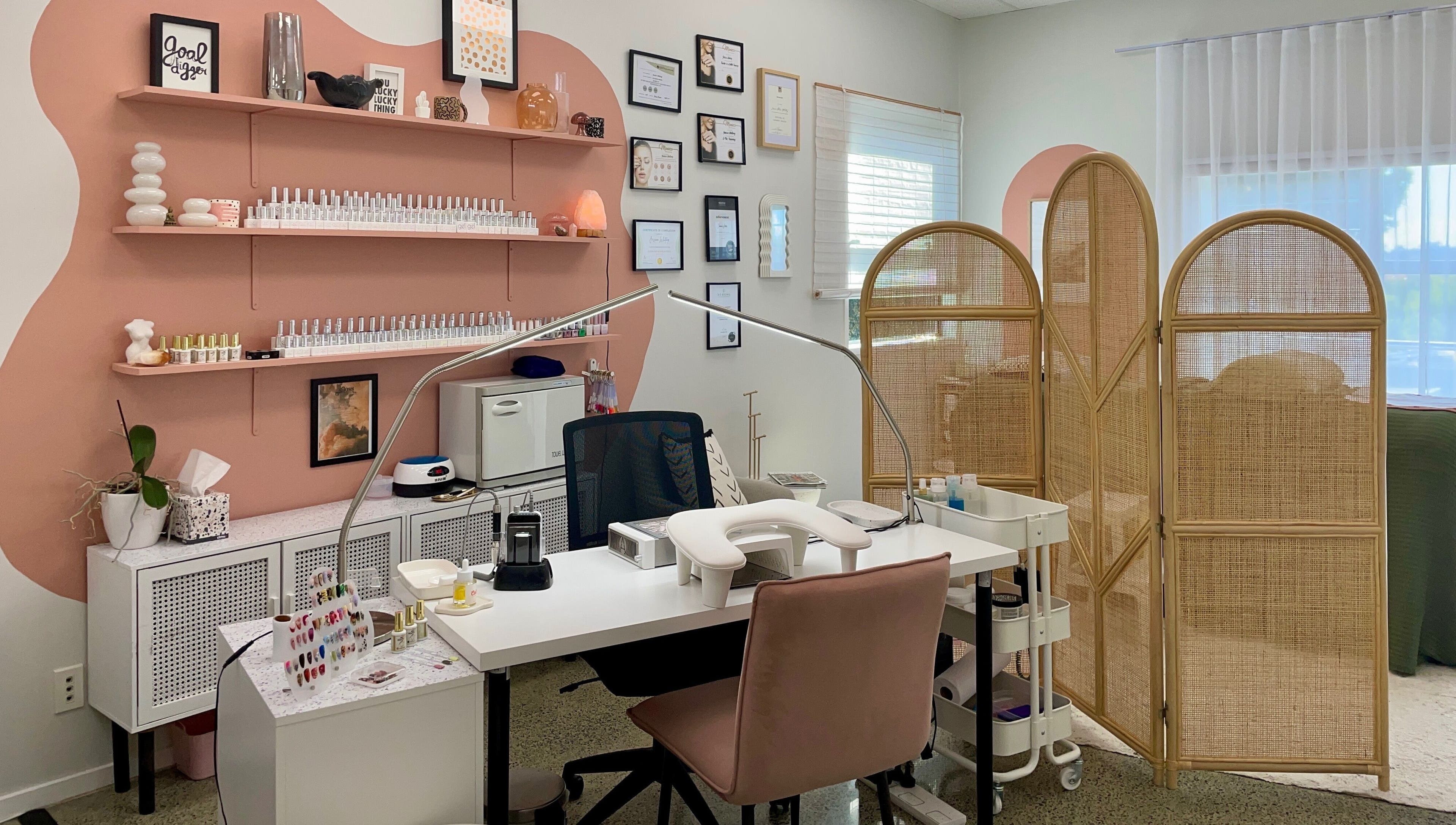 Gloss Salon's stylish nail station with pink accents in Mangawhai, Northland, NZ.