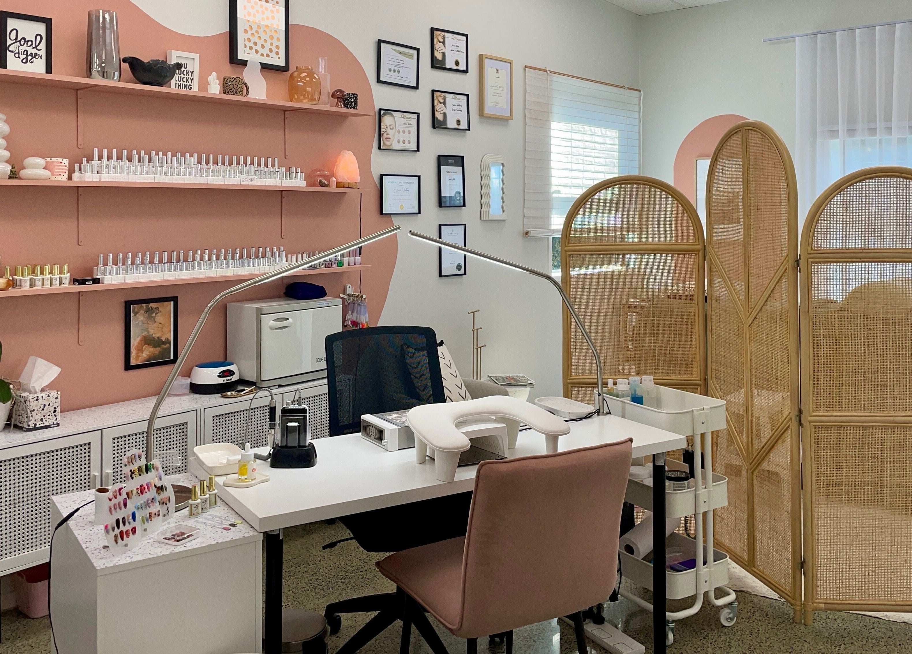 Gloss Salon's stylish nail station with pink accents in Mangawhai, Northland, NZ.