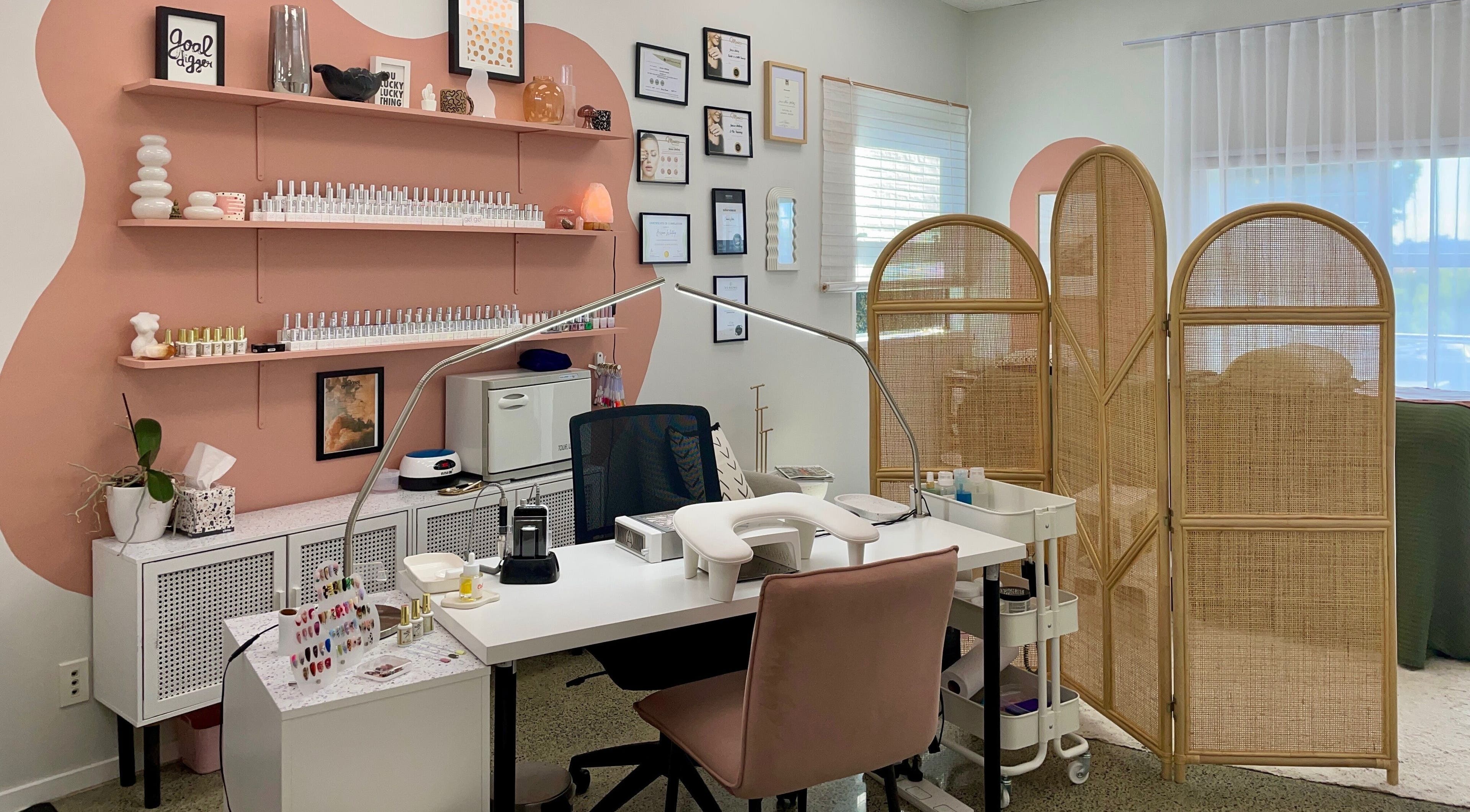 Gloss Salon's stylish nail station with pink accents in Mangawhai, Northland, NZ.