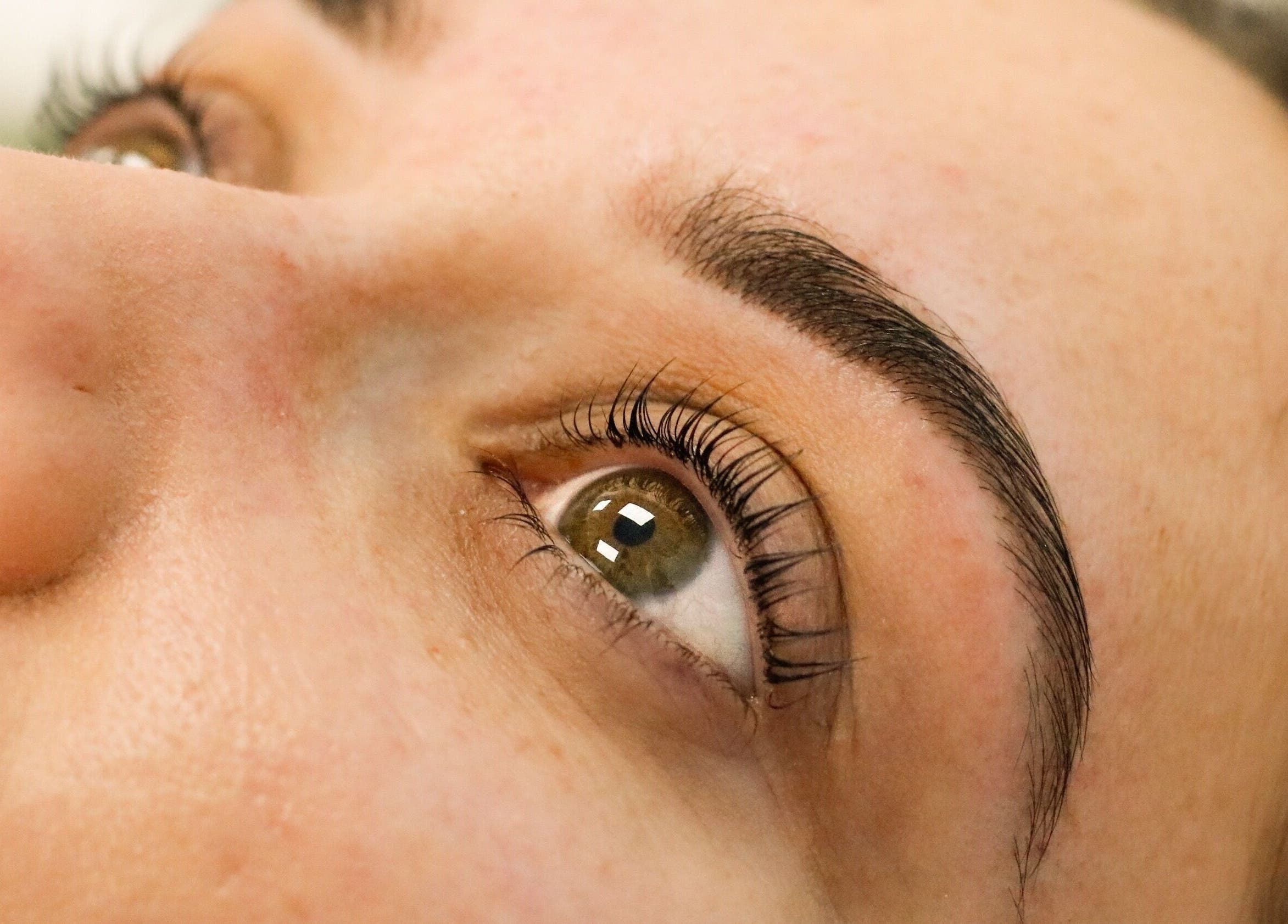 Close-up of perfectly shaped eyebrows and long lashes at Gloss Salon, Mangawhai, Northland, NZ.