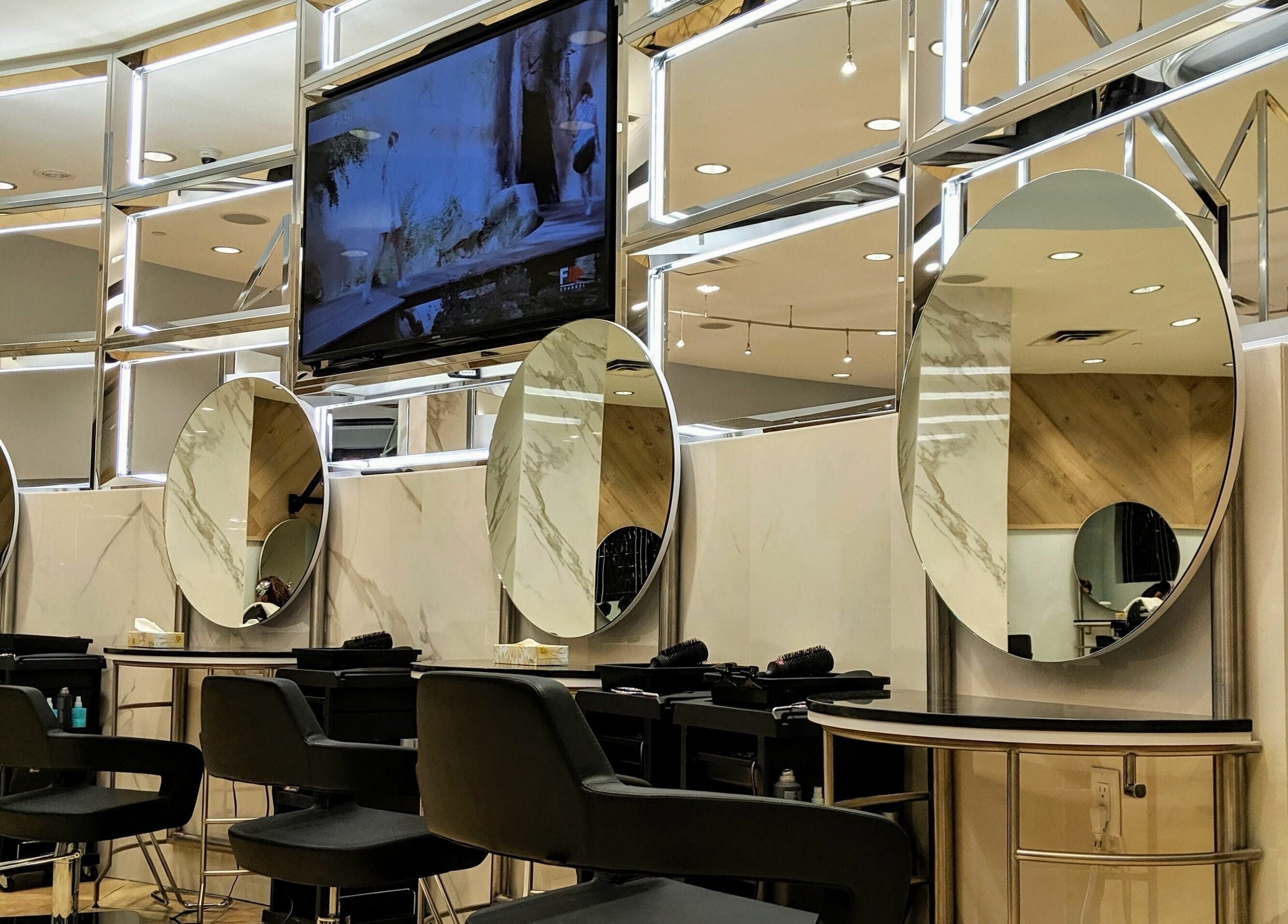 Luxurious salon interior at Salon Scavo, featuring modern mirror stations in Toronto, Ontario, CA.