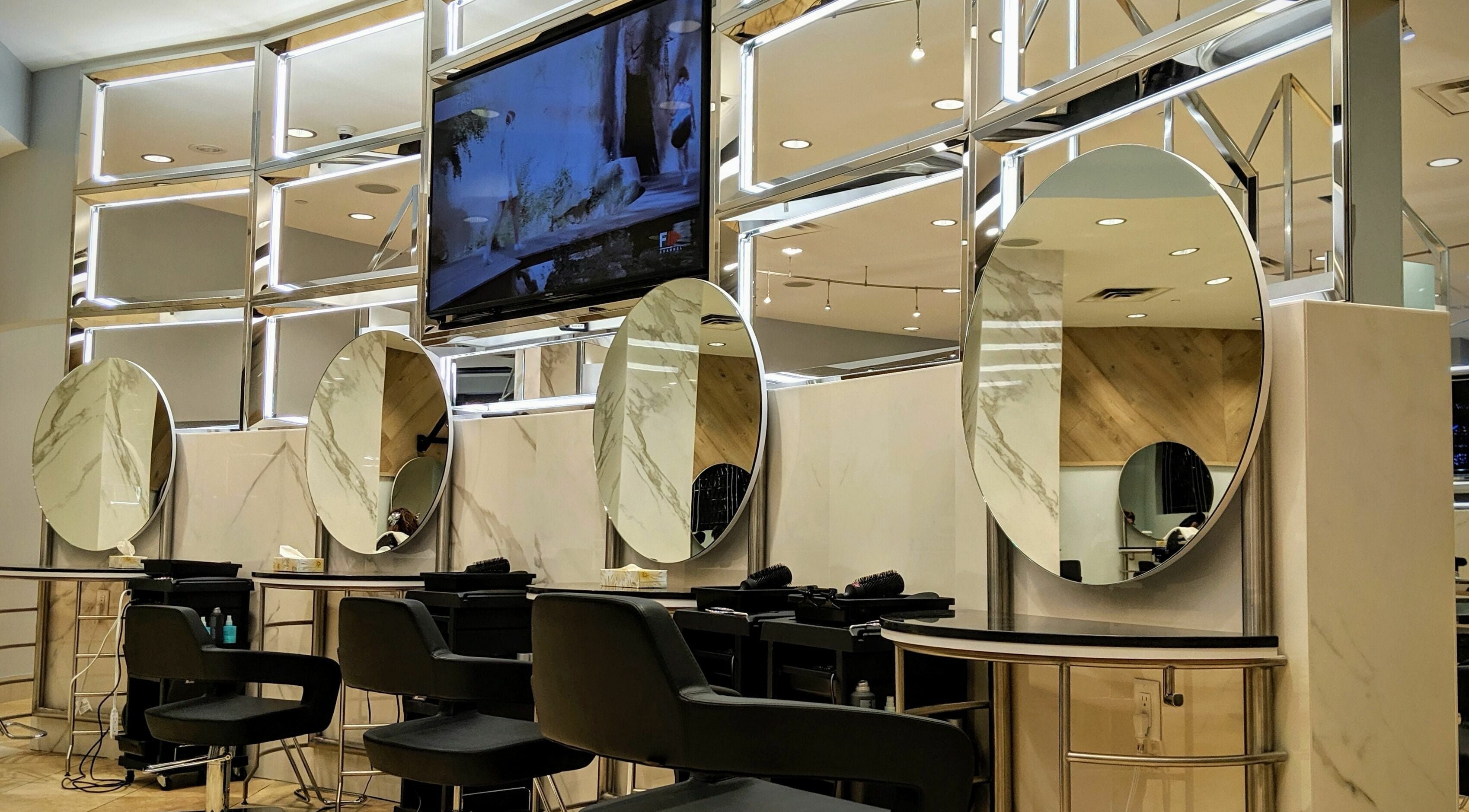 Luxurious salon interior at Salon Scavo, featuring modern mirror stations in Toronto, Ontario, CA.