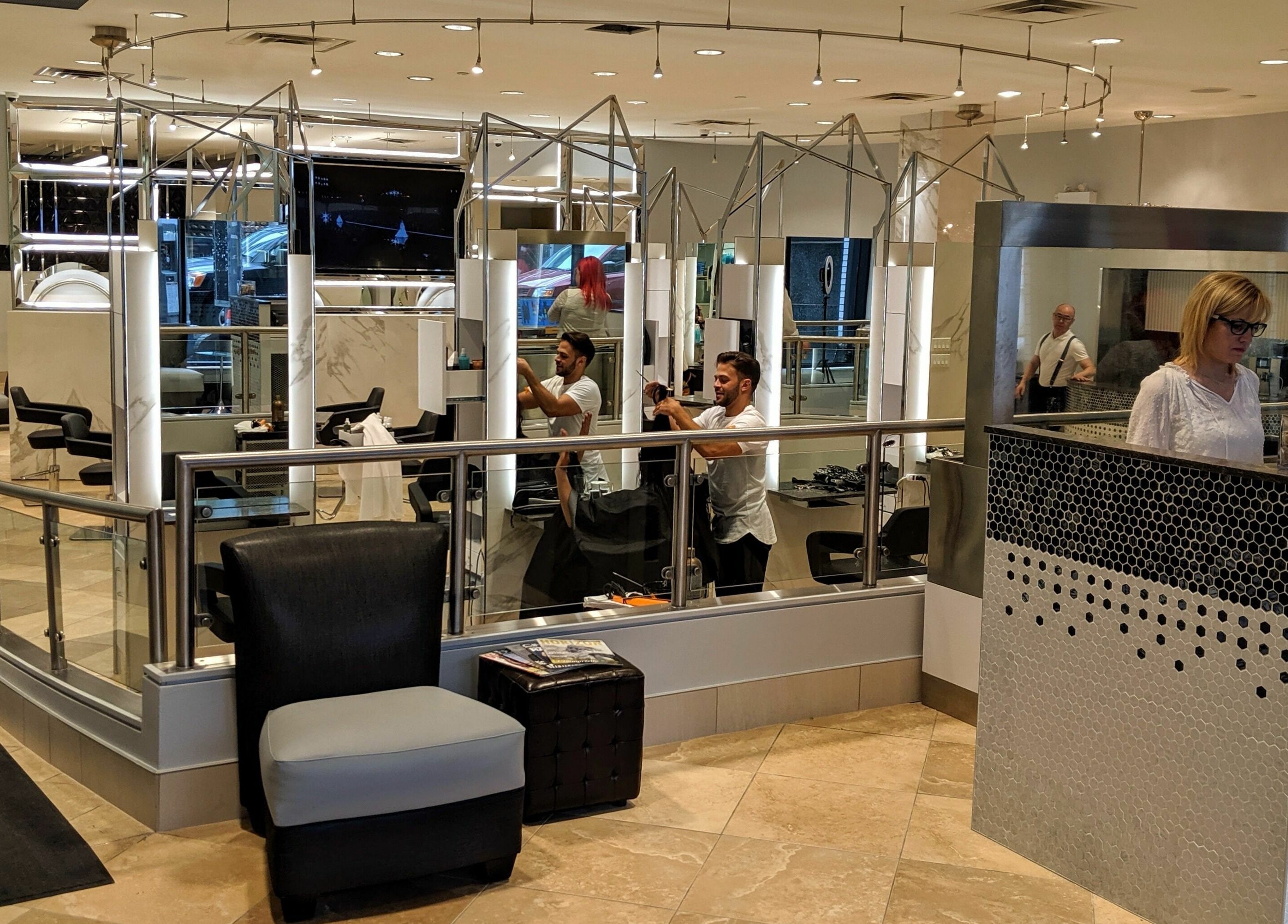 Bright interior of Salon Scavo in Toronto, Ontario, CA with stylists and modern decor.