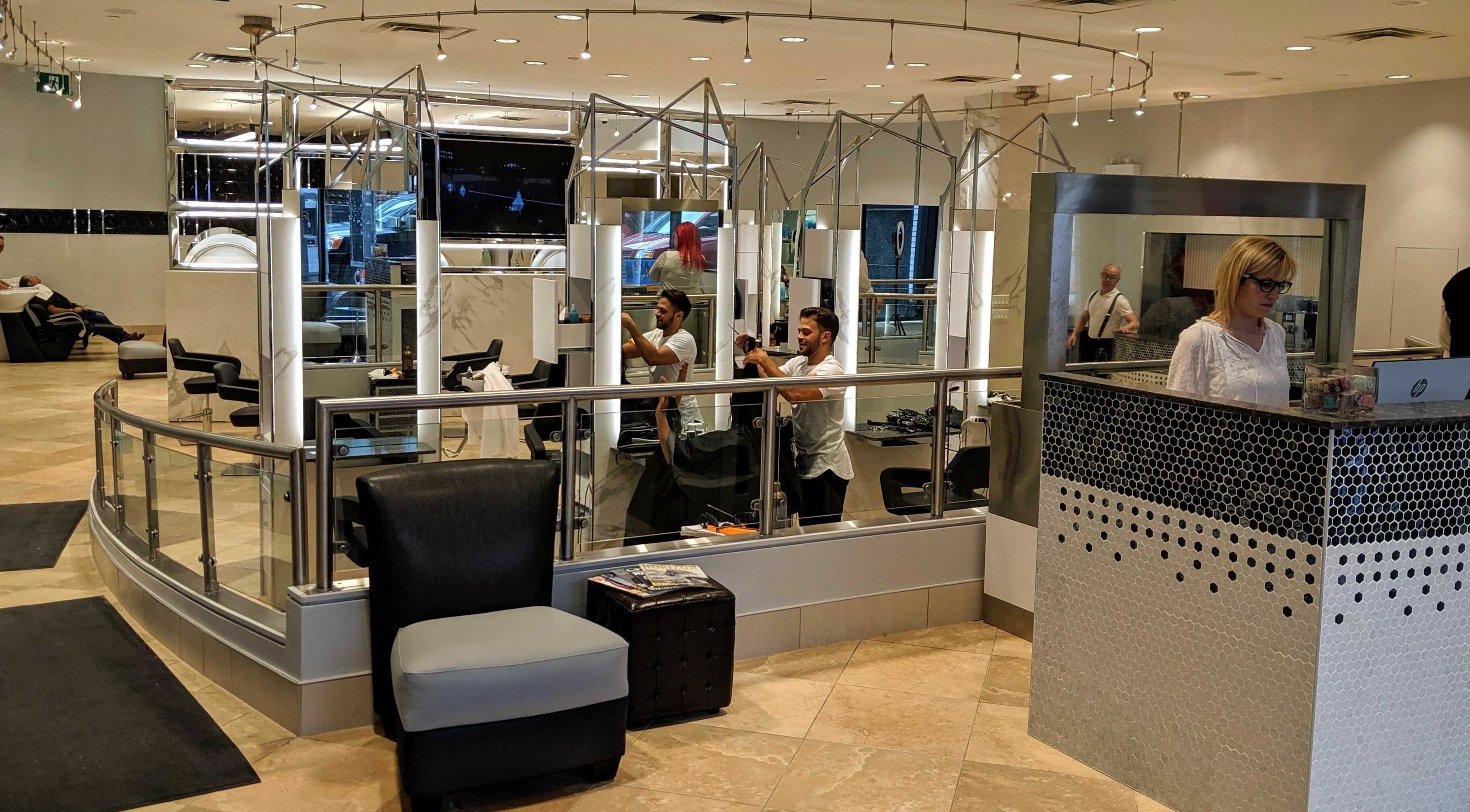 Bright interior of Salon Scavo in Toronto, Ontario, CA with stylists and modern decor.