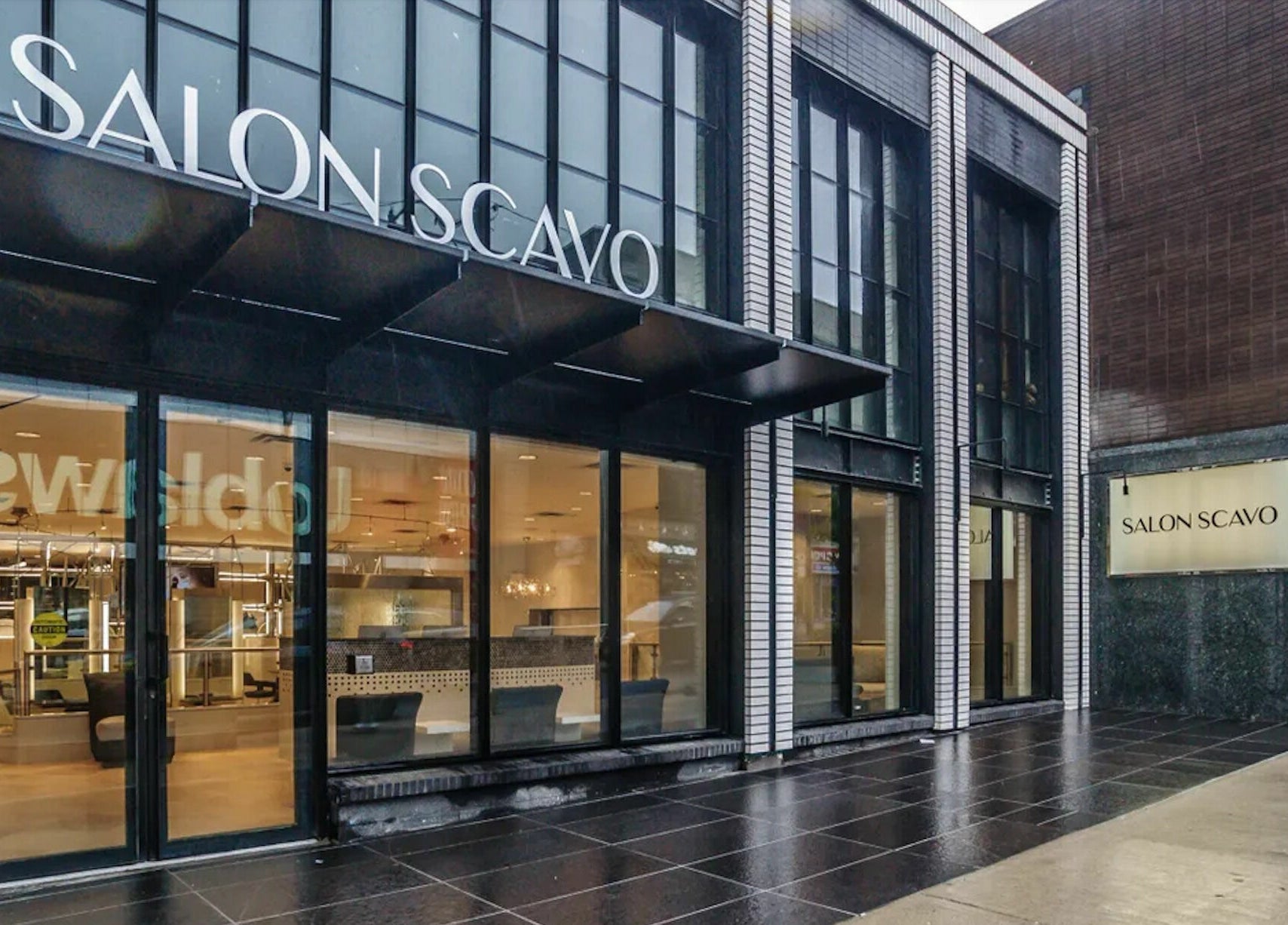 Exterior of Salon Scavo, Toronto, Ontario, CA showcasing modern design and inviting glass doors.