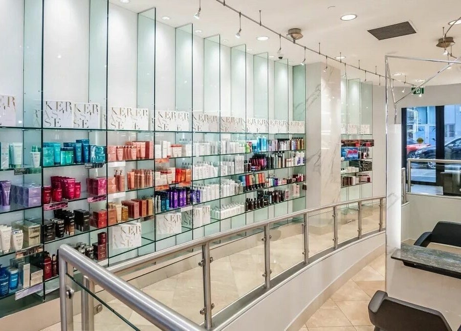 Elegant salon display at Salon Scavo, Toronto, Ontario, CA showcasing professional beauty products on sleek shelves.