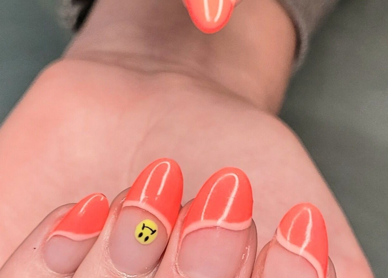 Vibrant neon nails with smiley design at Nails by Snow in Pretoria, Gauteng, ZA. Creative nail art showcased.