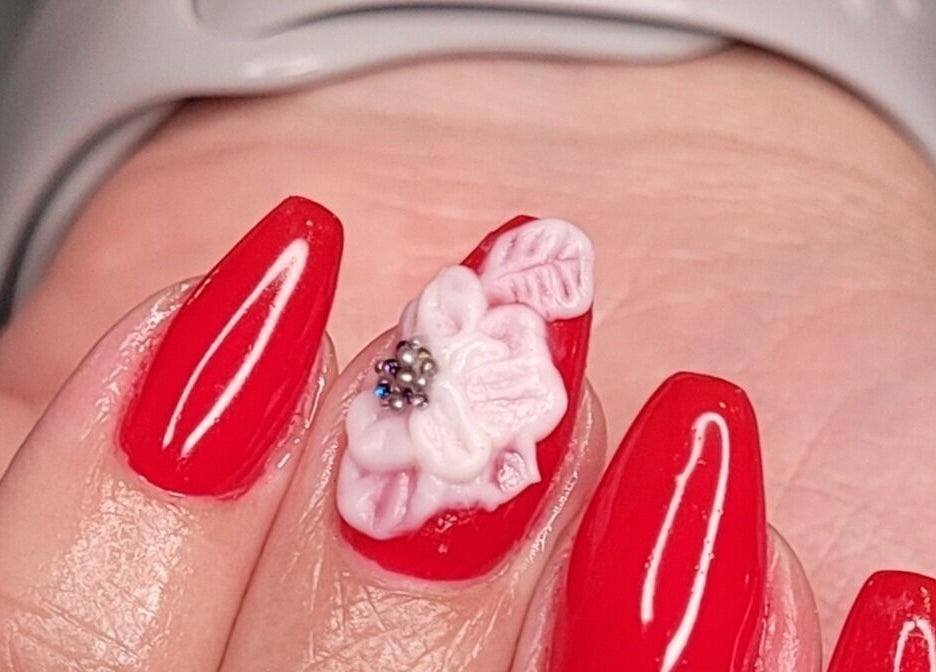 Elegant red nails with 3D floral art at Nails by Snow, Pretoria, Gauteng, ZA.