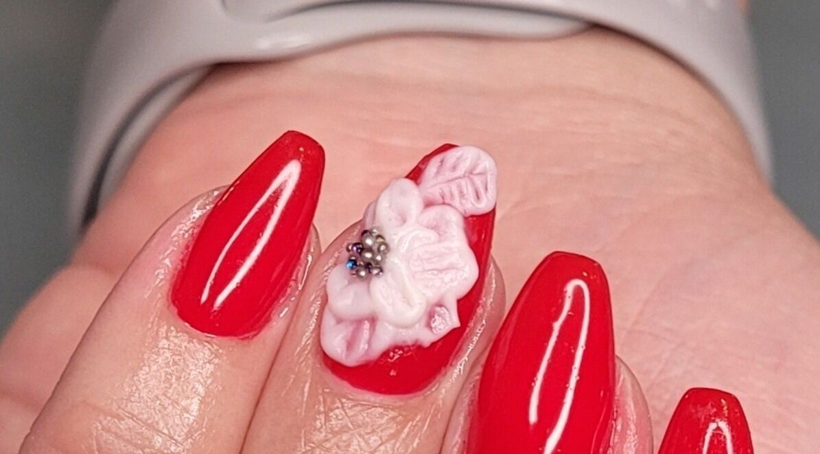Elegant red nails with 3D floral art at Nails by Snow, Pretoria, Gauteng, ZA.
