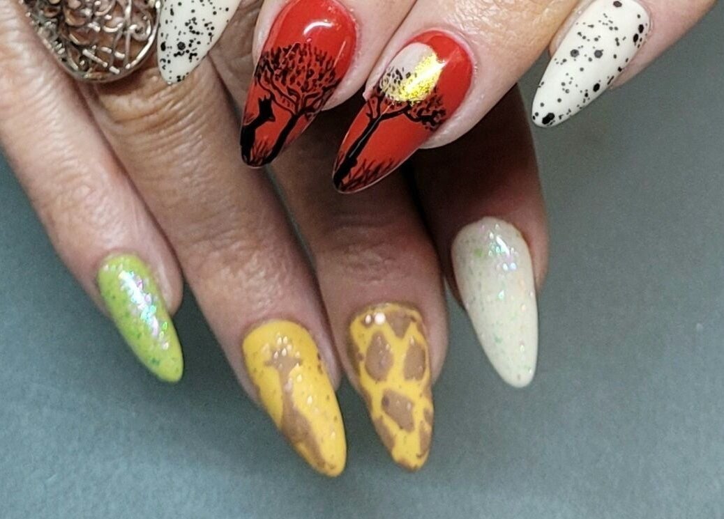 Vibrant safari-themed nail art from Nails by Snow, Pretoria, Gauteng, ZA. Red, yellow, green, and speckled nails.