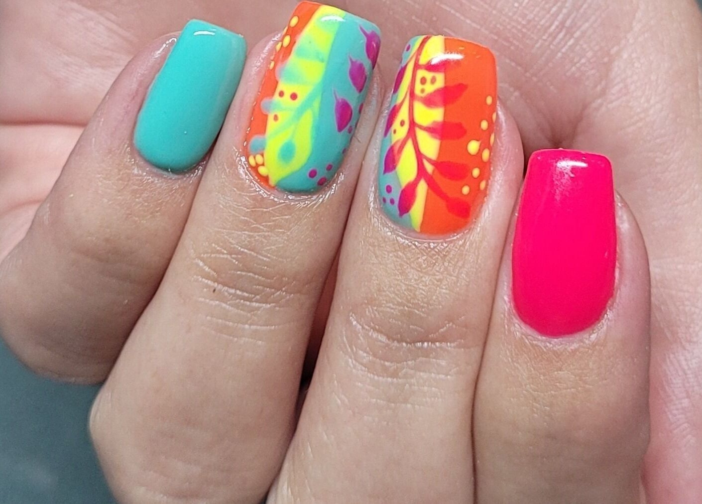 Colorful nail art at Nails by Snow, Pretoria, Gauteng, ZA, showcasing detailed floral designs.