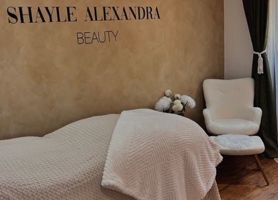 Tranquil treatment room at Shayle Alexandra Beauty, Camberley, England with cozy bed and elegant decor.