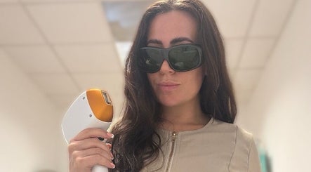 Professional laser hair removal at Glow Skin Bar, Newcastle, England, GB. Woman holding laser equipment.