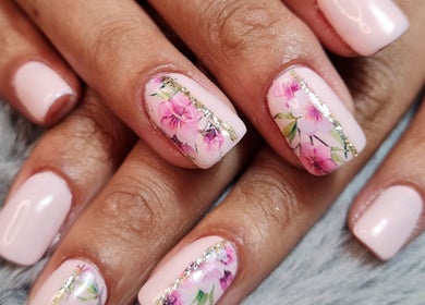 Elegant floral nail art design at Ria Dharni, Crawley, England, GB showcasing intricate pink blossoms.