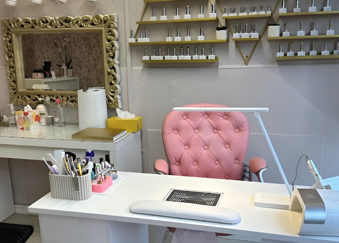 Elegant beauty station at Sophie beauty brow & Lash, Glasgow, Scotland, GB, featuring a pink chair and ornate mirror.