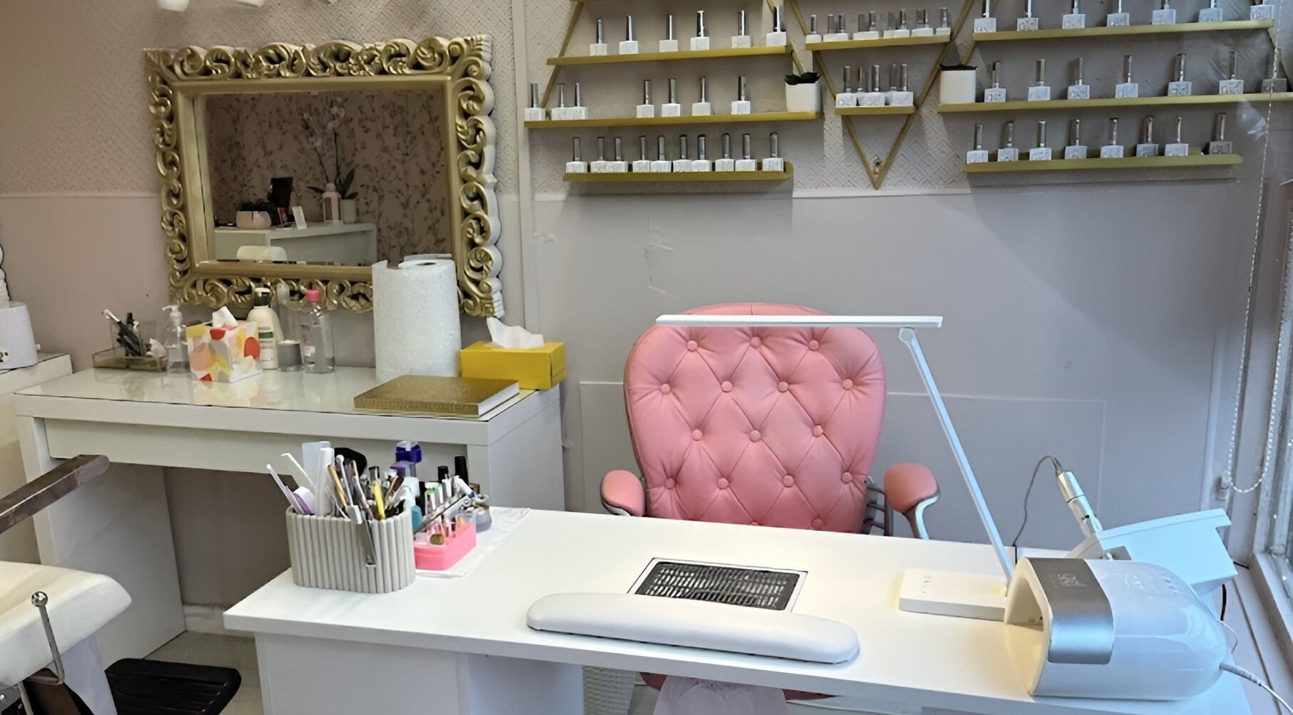 Elegant beauty station at Sophie beauty brow & Lash, Glasgow, Scotland, GB, featuring a pink chair and ornate mirror.