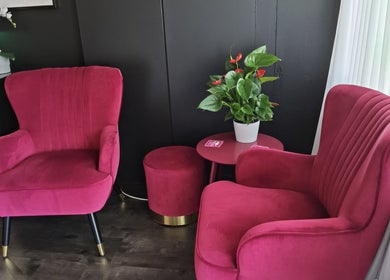 Luxurious pink velvet chairs at Empire Day Spa in Richmond, Victoria, AU create an inviting relaxation corner.