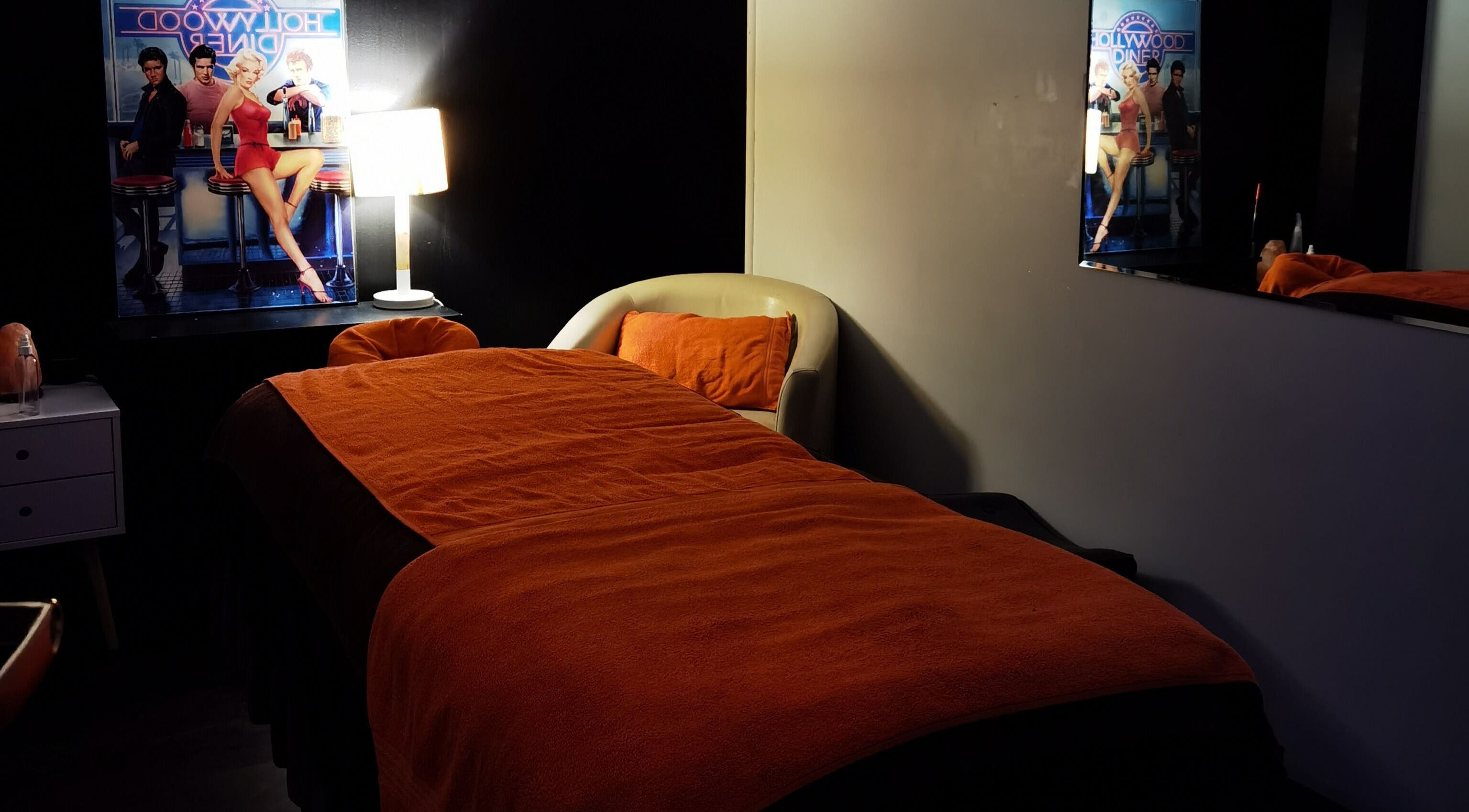 Cozy spa room with vintage decor at Empire Day Spa, Richmond, Victoria, AU. Relaxing massage bed under warm lighting.