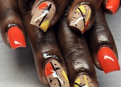 Stunning vibrant nail art at Jai'sNails, Bridgetown, Saint Michael, BB. Abstract design with red, yellow, and black accents.